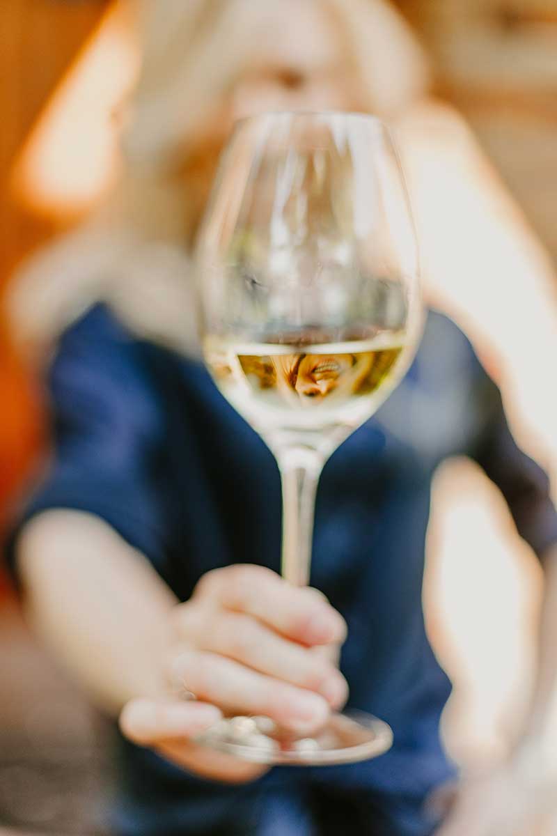 Meet-Iola-Wines---homepage woman holding wine glass